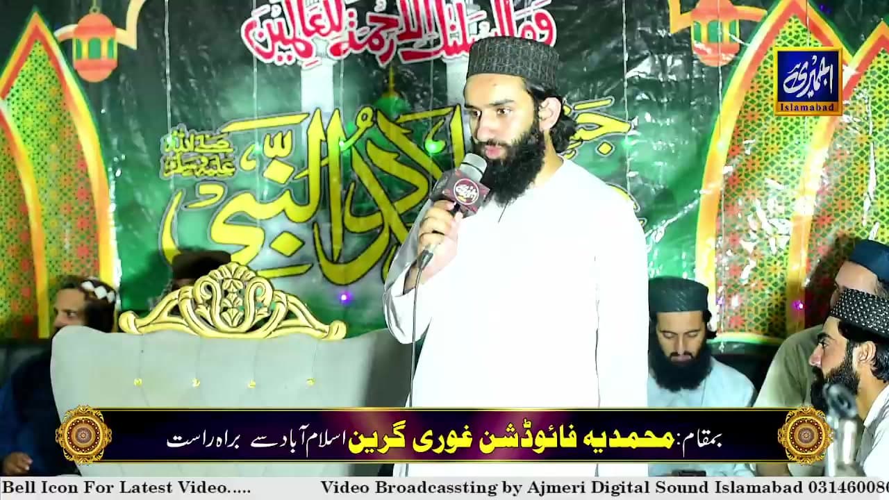 A speaker addressing a community gathering hosted by Muhammadi Foundation in Islamabad.